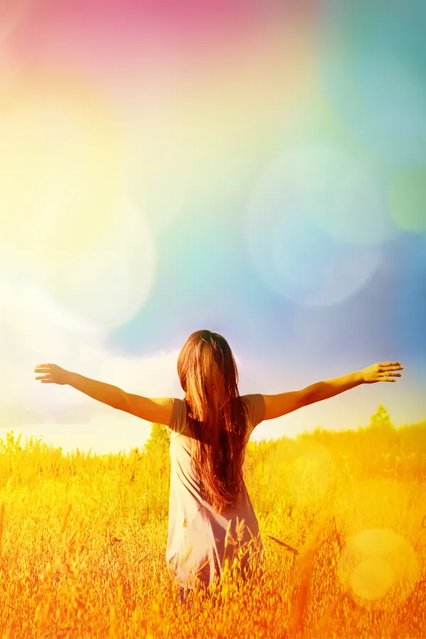 A woman free from joint pain holds her arms out in a sunny field. Get biologic allograft treatment from Don D. Fisher, D.O. at The BEST Program in Fort Lauderdale.