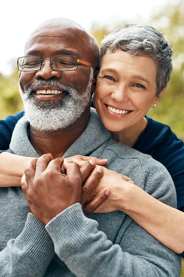 A mature couple embraces outside. Get CJC 1295 anti-aging peptides from Don D. Fisher, D.O. at The BEST Program in Fort Lauderdale.
