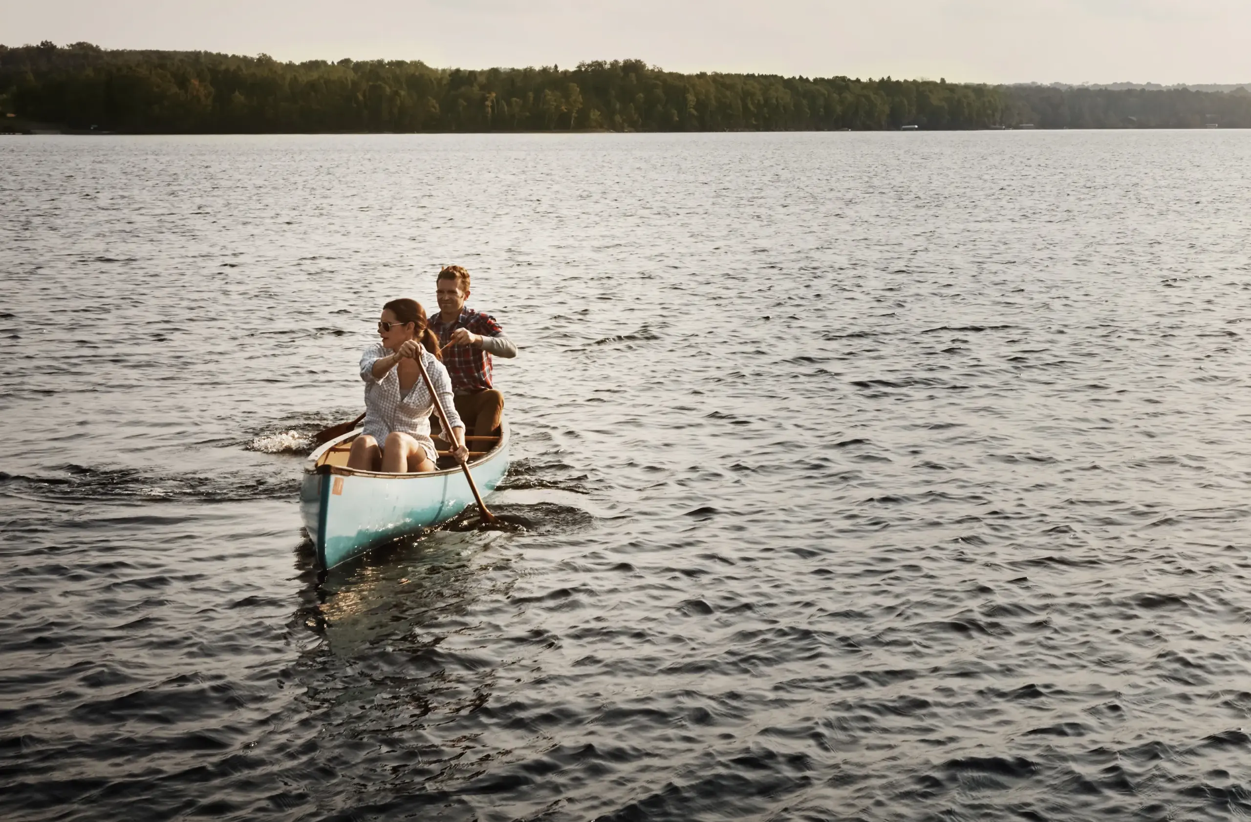 A couple takes a canoe out on a lake. Get HGH hormone therapy from Don D. Fisher, D.O. at The BEST Program in Fort Lauderdale.