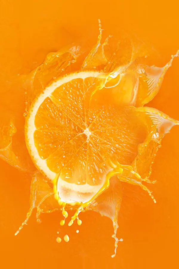 An orange slice dropped into orange juice. Get High Dose Vitaman C IV treatment from Don D. Fisher, D.O. at The BEST Program in Fort Lauderdale.