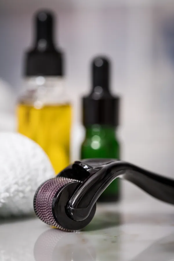 Close up of oils, a towel, and a microneedling tool used by Don D. Fisher, D.O. at The BEST Program in Fort Lauderdale.