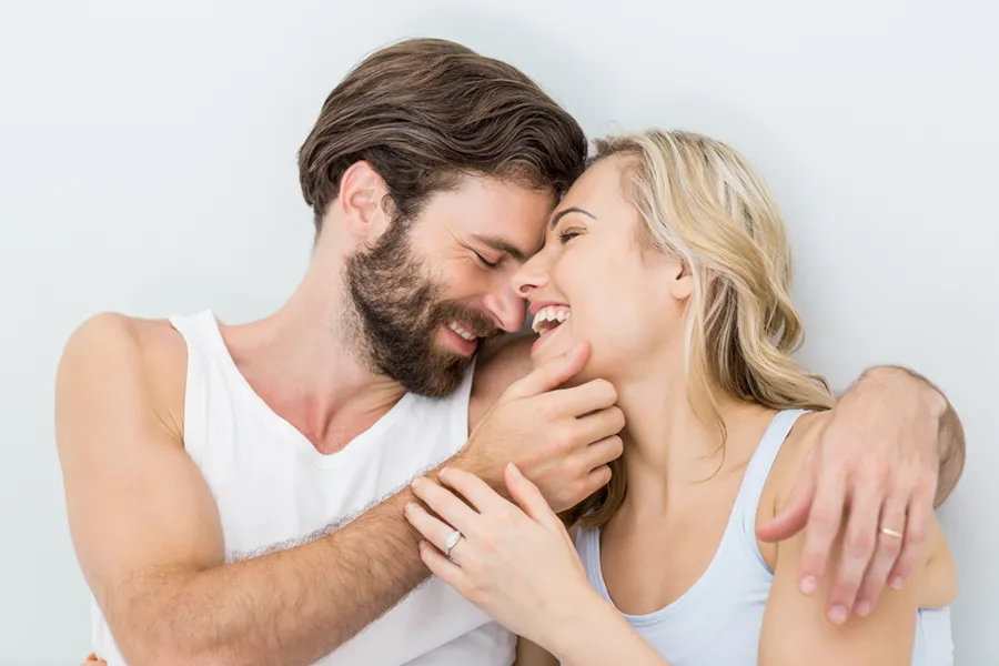 A joyful image of a couple playfully embracing each other. PRP for Erectile Dysfunction offered by Don D. Fisher, D.O. at The BEST Program in Fort Lauderdale.