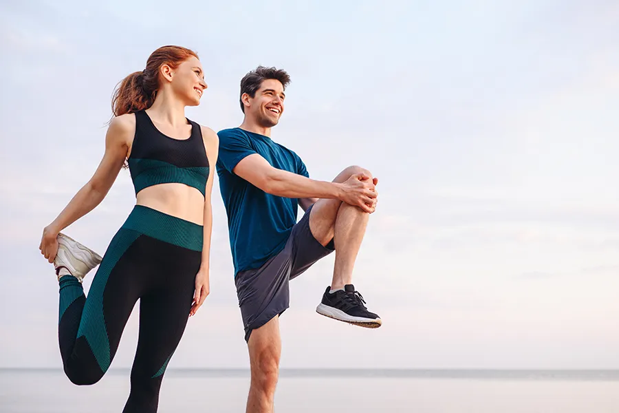 A couple stretches before a run. Schedule the Recovery peptide blend from Don D. Fisher, D.O. at The BEST Program in Fort Lauderdale.