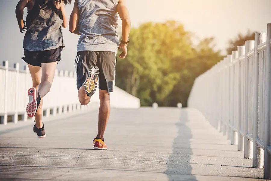 A couple runs across a bridge on a nice afternoon. Schedule Thymosin Beta 4 peptide therapy for immune function and weight loss from Don D. Fisher, D.O. at The BEST Program in Fort Lauderdale.