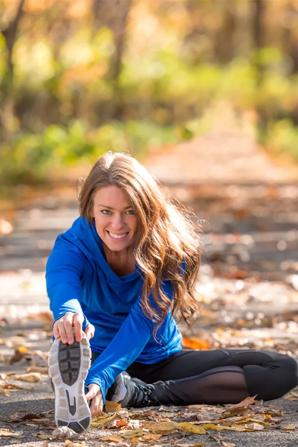 A woman stretches before a run on the trail. Get Thymosin Beta 4 peptide therapy for immune function and weight loss from Don D. Fisher, D.O. at The BEST Program in Fort Lauderdale.
